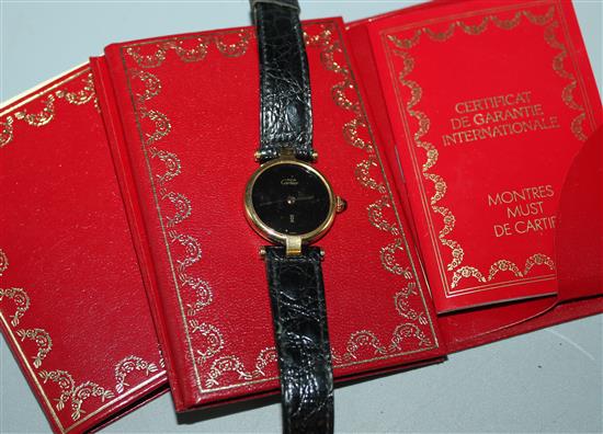 Ladies Must de Cartier silver gilt wristwatch, circular black dial and cabochon sapphire winder